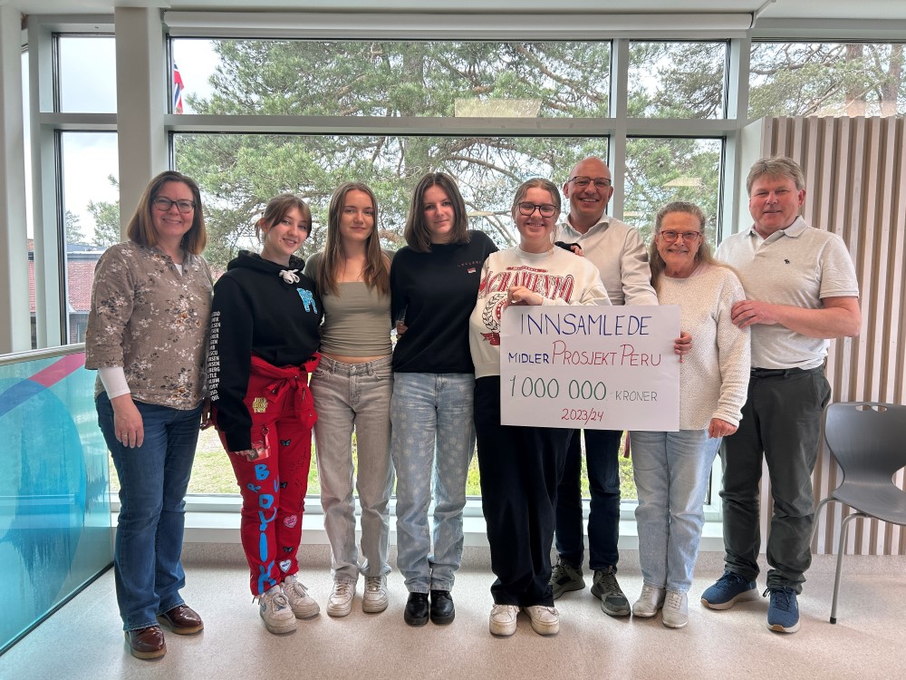 Oppstilt bilde av Perukomiteen og styret som mottar sjekk